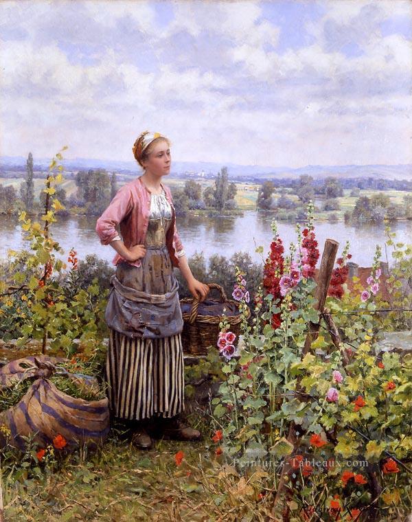 Maria sur la terrasse avec une liasse de pelouse Daniel Ridgway Knight Flowers Peintures à l'huile